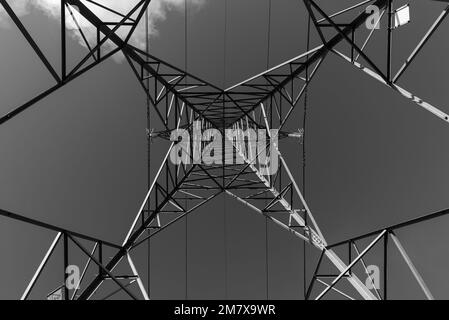 Black and white image of an electricity pylon viewed from directly underneath Stock Photo