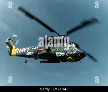 A right side air-to-air view of an SH-2 Seasprite Mark 1 Light Airborne Multi-Purpose System (LAMPS) helicopter. Note the surface search radar, ASQ-81 Magnetic Anomaly Detection (MAD) gear mounted on the right side and the anti-submarine warfare torpedo on the left. Country: Unknown Stock Photo