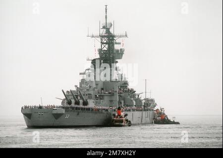 Crewmen stand at the rail of the battleship NEW JERSEY (BB-62) as a tug boats help the ship get underway at the start of its sea trials. The NEW JERSEY has been renovated and will be recommissioned in January 1983. Base: San Pedro Bay State: California (CA) Country: United States Of America (USA) Stock Photo