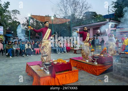 Pokhara, Nepal - December 2nd, 2022 - Hindu  Monks chanting sacred mantras to bless people and offering goods to deiity Stock Photo