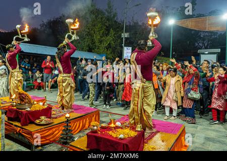 Pokhara, Nepal - December 2nd, 2022 - Hindu  Monks chanting sacred mantras to bless people and offering goods to deiity Stock Photo