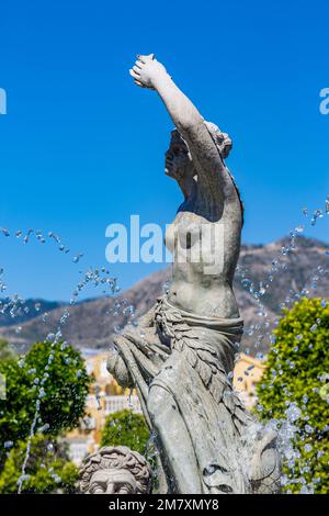 Female statue in the fountain with water jets near it, sunny spring view from 'Parque de la Batería' in Torremolinos, Málaga, Spain Stock Photo