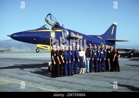 Entertainers John Travolta and Olivia Newton John, center, along with pilots of the Navy's Blue Angels flight demonstration team pose in front of an A-4F Skyhawk aircraft parked on the apron. The Blue Angels performed during a local air show. Base: Salinas State: California (CA) Country: United States Of America (USA) Stock Photo