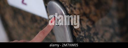 Female finger with presses elevator button closeup Stock Photo