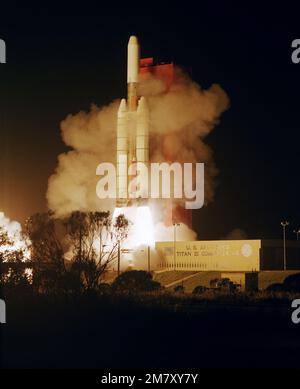 A Titan III 34D/Inertial Upper Stage (IUS) launch vehicle, carrying a DSCS-II and a DSCS-III (Defense Satellite Communications System), lifts off from Complex 40 at 12:05 a.m. Base: Cape Canaveral Air Force Station State: Florida (FL) Country: United States Of America (USA) Stock Photo