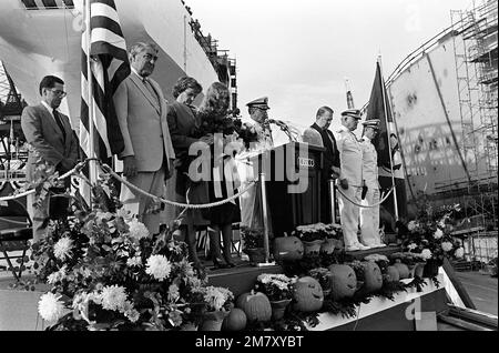 Edwin Meese III, counselor to the president, (right of the podium) stands on the speakers platform with other dignitaries for a moment of silence, during the launching ceremony for the cable repair ship USNS ZEUS (T-ARC-7). The ship was built by the National Steel and Shipbuilding Company. Base: San Diego State: California (CA) Country: United States Of America (USA) Stock Photo