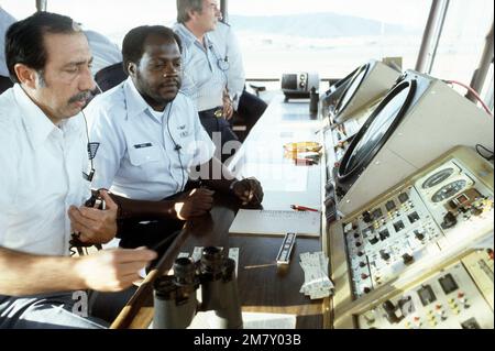 MSGT Charlie Parker receives instruction on the operation of a radar scope from a civilian air traffic controller in the control tower of San Francisco International Airport. Base: San Francisco State: California (CA) Country: United States Of America (USA) Stock Photo
