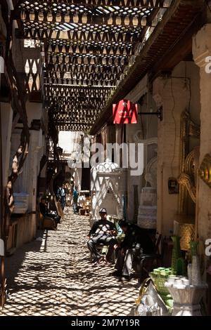 Fez, Morocco-April 23, 2014: Group of people sitting in a wedding shops wating customers during a nice spring morning in the Medina of Fez Stock Photo