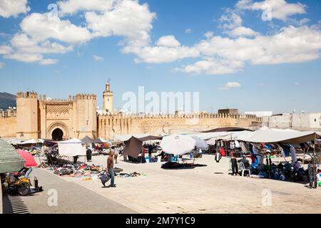 Fez, Marocco-April 23, 2014: Moroccans selling clothes on local market, many people watching and buying; Fes-Boulemane región, North Africa Stock Photo