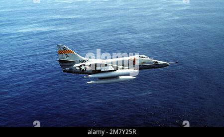 Right side view of a Navy A-4 Skyhawk aircraft banking to the left ...