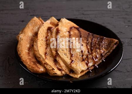 photo three pancakes lying in the shape of a triangle on a plate Stock Photo