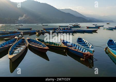 Pokhara, Nepal ; DEcember 4th, 2022; Multi coloured Boats moored  in Phewa Lake Stock Photo