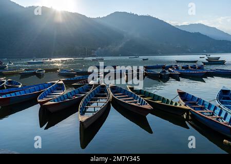 Pokhara, Nepal ; DEcember 4th, 2022; Multi coloured Boats moored  in Phewa Lake Stock Photo