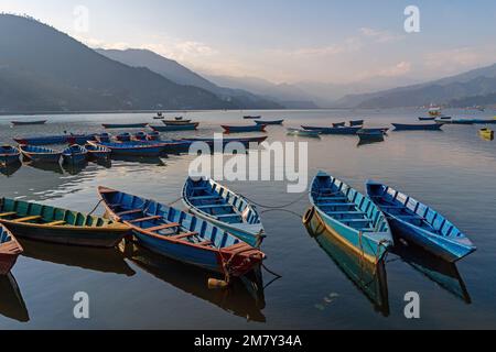 Pokhara, Nepal ; DEcember 4th, 2022; Multi coloured Boats moored  in Phewa Lake Stock Photo