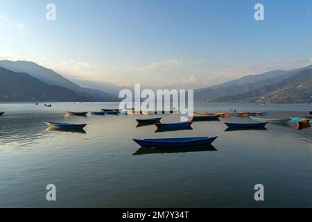 Pokhara, Nepal ; DEcember 4th, 2022; Multi coloured Boats moored  in Phewa Lake Stock Photo