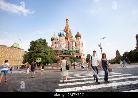 Moscow, Russia-July 20, 2010. Many tourists visit St. Basil's Cathedral on Red Square in Moscow, and taking pictures in front of the cathedral Stock Photo