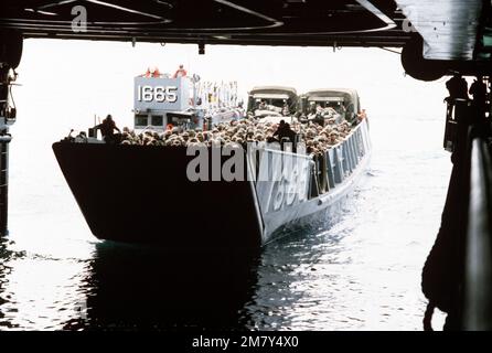 A landing craft utility enters the well deck of the amphibious assault ...