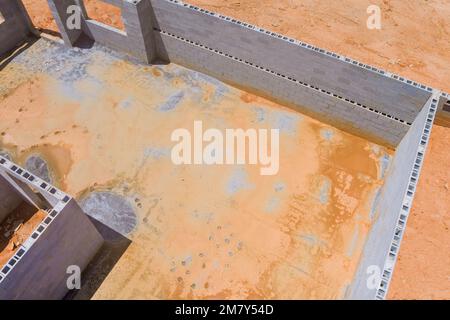 House under construction an concrete block bricks to wall for foundation on building site Stock Photo