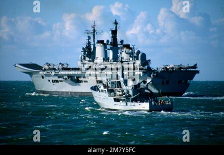 HMS Illustrious was a light aircraft carrier of the Royal Navy and the second of three Invincible-class ships constructed in the late 1970s and early 1980s. She was the fifth warship and second aircraft carrier to bear the name Illustrious, and was affectionately known to her crew as 'Lusty'. In 1982, the conflict in the Falklands necessitated that Illustrious be completed and rushed south to join her sister ship HMS Invincible and the veteran carrier HMS Hermes. To this end, she was brought forward by three months for completion at Swan Hunter Shipyard, then commissioned on 20 June 1982 at se Stock Photo