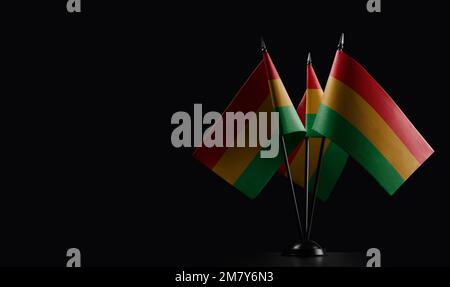 Small national flags of the Bolivia on a black background. Stock Photo