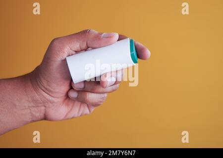 young man putting artificial sweetener in tea, Stock Photo