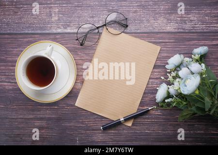 top view of Old Paper texture ,tea , flower on table  Stock Photo