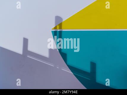 Blurred shadow of geometric figures on colorful wall Stock Photo