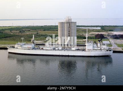 An aerial port beam view of the navigation research ship USNS VANGUARD (T-AG 194) moored at a wharf. Country: Unknown Stock Photo