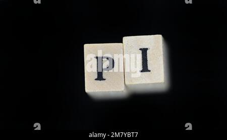 The world pi is made with wooden cubes on a black background Stock Photo