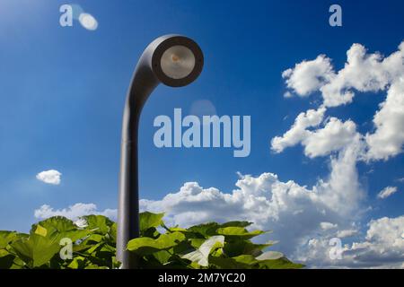 Modern street lighting lamppost at daytime against a blue sky Stock Photo