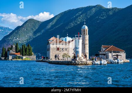 Departing Our Lady of the Rocks, with the Island of Saint George on the left, off the coast of Perast in the Bay of Kotor in Montenegro Stock Photo