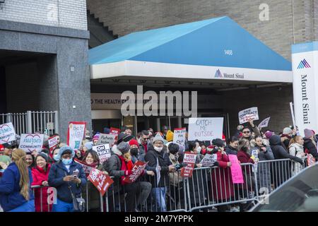 More than 7,000 nurses at Mount Sinai Medical Center and Montefiore Medical Center are seeking better wages and working conditions.   Hundreds of striking nurses and their supporters lined both sides of Madison Avenue in front of Mount Sinai Hospital on Monday January 9, 2023 waving signs, blowing horns and calling for a labor contract that will require more nurses at the bedside for patients. Stock Photo