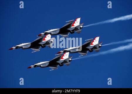 An air-to-air left side view of four USAF Thunderbird Air Demonstration Squadron F-16 Fighting Falcons in a diamond formation during their first air show. Base: Nellis Air Force Base State: Nevada (NV) Country: United States Of America (USA) Stock Photo