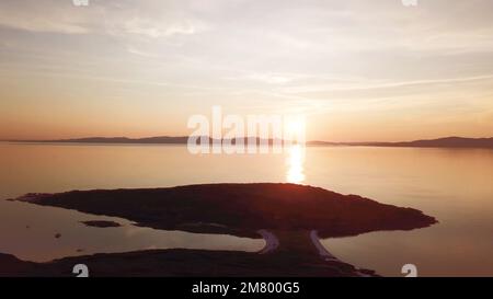 View of Isle of Jura and the Isle of Islay, Hebrides, Scotland from The Isle of Gigha at sunset Stock Photo