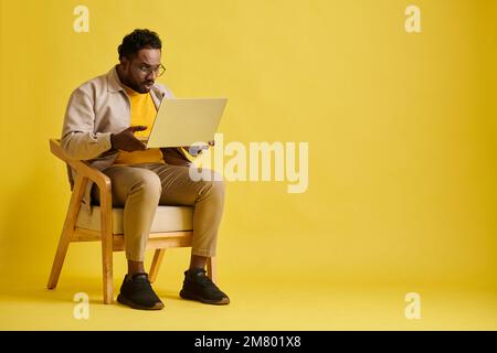 Emotional businessman reading news on cryptocurrency on laptop Stock Photo