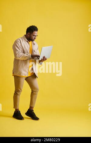 Serious software developer checking programming code on laptop screen Stock Photo