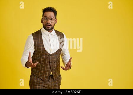 Studio portrait of emotional excited or shocked man in glasses Stock Photo