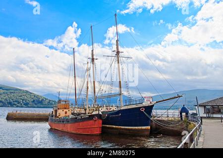 Inveraray, Scotland - July 07, 2015 : An old 1911 schooner and the Vital Spark, a famous Clyde Puffer boat moored at Inveraray Pier in loch Fyne in th Stock Photo