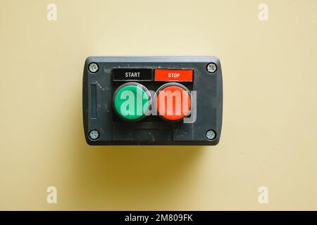 Device with start button and stop button on the wall. Close-up. Stock Photo