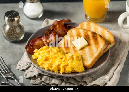 Homemade American Scrambled Egg Breakfast with Bacon and Toast Stock Photo