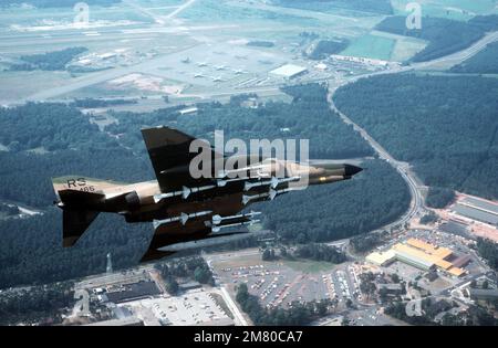 An underside view of an F-4E Phantom II aircraft from the 526th Tactical Fighter Squadron making a landing approach. The aircraft is armed with four AIM-7 Sparrow missiles, front, and four AIM-9 Sidewinder air-to-air missiles, back. Base: Ramstein Air Base State: Rheinland-Pfalz Country: Deutschland / Germany (DEU) Stock Photo