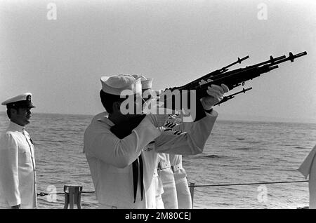 An honor guard fires a 21-gun salute at the conclusion of the burial-at-sea ceremony for LCDR Albert A. Schaufelberger. Schaufelberger was killed in San Salvador. Base: San Diego State: California (CA) Country: United States Of America (USA) Stock Photo