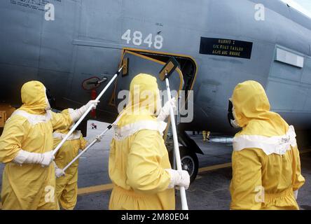 Members of the Disaster Response Force, wearing nuclear-biological-chemical (NBC) protective suits 'decontaminate' an aircraft by washing it down during Exercise Global Shield at the Strategic Air Command (SAC) headquarters. Base: Offutt Air Force Base State: Nebraska (NE) Country: United States Of America (USA) Stock Photo