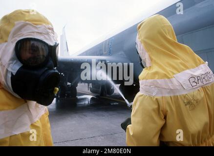 Members of the Disaster Response Force, wearing nuclear-biological-chemical (NBC) protective suits, 'decontaminate' an aircraft by washing it down during Exercise Global Shield at the Strategic Air Command (SAC) headquarters. Base: Offutt Air Force Base State: Nebraska (NE) Country: United States Of America (USA) Stock Photo