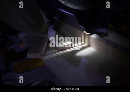 Sawing board with large disc. Details of working with tool on wood. Furniture creation workshop. Stock Photo