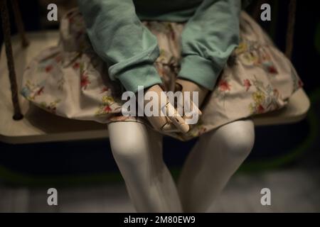 Mannequin in dress. Children's mannequin in clothing store. Plastic hands. Fashion details. Stock Photo