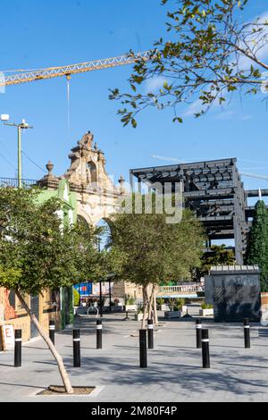 quarry stone arch in contrast to a building under construction in the steel background Stock Photo
