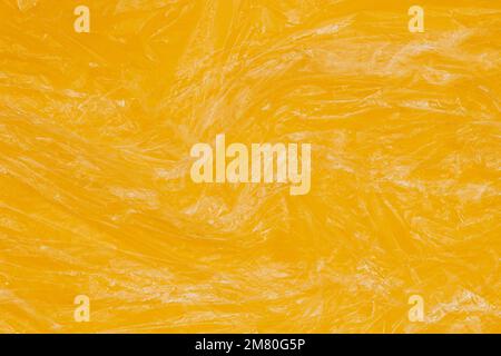 Crumpled wrinkled plastic transparent plastic cellophane wrapper on yellow color background. Abstract creative texture banner background Stock Photo