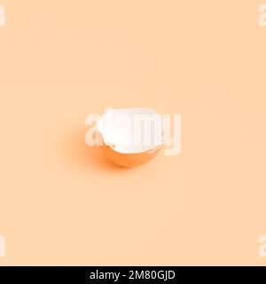 Half of an eggshell on a beige background. isolate Stock Photo
