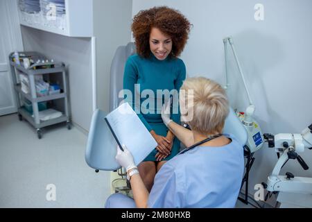 Curly-haired woman having an examination at the gynecologist office Stock Photo